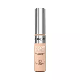 Photo du tube Accord Parfait Serum Anti-Cernes sur fond blanc. Le flacon transparent laisse voir la texture beige et possede un bouchon argente brillant. L'etiquette precise la formule enrichie a 1,5 % d'acide hyaluronique et de cafeine.