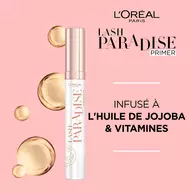 Visuel du Lash Paradise Primer sur fond rose, mettant en avant la formule « Infuse a l'huile de jojoba & vitamines » entouree de gouttes dorees.​