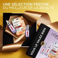 Un coffret cadeau L'Oreal Paris Revitalift Filler et un sachet de masque facial disposes sur un ruban dore. Le coffret est etiquete "Vous le valez bien"​