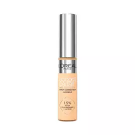 Photo du tube Accord Parfait Serum Anti-Cernes sur fond blanc. Le flacon transparent laisse voir la texture beige et possede un bouchon argente brillant. L'etiquette precise la formule enrichie a 1,5 % d'acide hyaluronique et de cafeine.