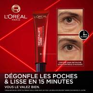 Tube de L'Oreal Paris Revitalift Laser Correcteur de poches instantane avec comparaison avant/apres 15 minutes sur le contour de l’oeil, mettant en avant la reduction visible des poches.