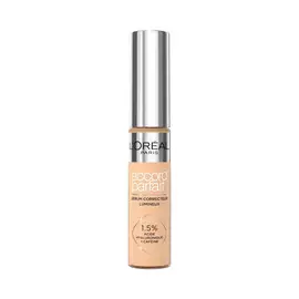 Photo du tube Accord Parfait Serum Anti-Cernes sur fond blanc. Le flacon transparent laisse voir la texture beige et possede un bouchon argente brillant. L'etiquette precise la formule enrichie a 1,5 % d'acide hyaluronique et de cafeine.